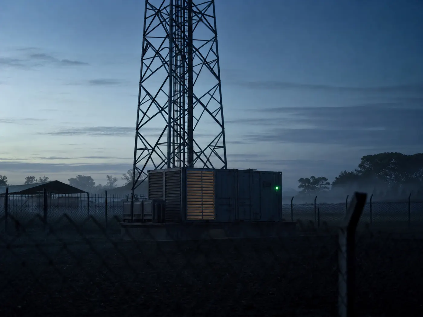 A monitored generator at a DRC telecom tower compound before sunrise
